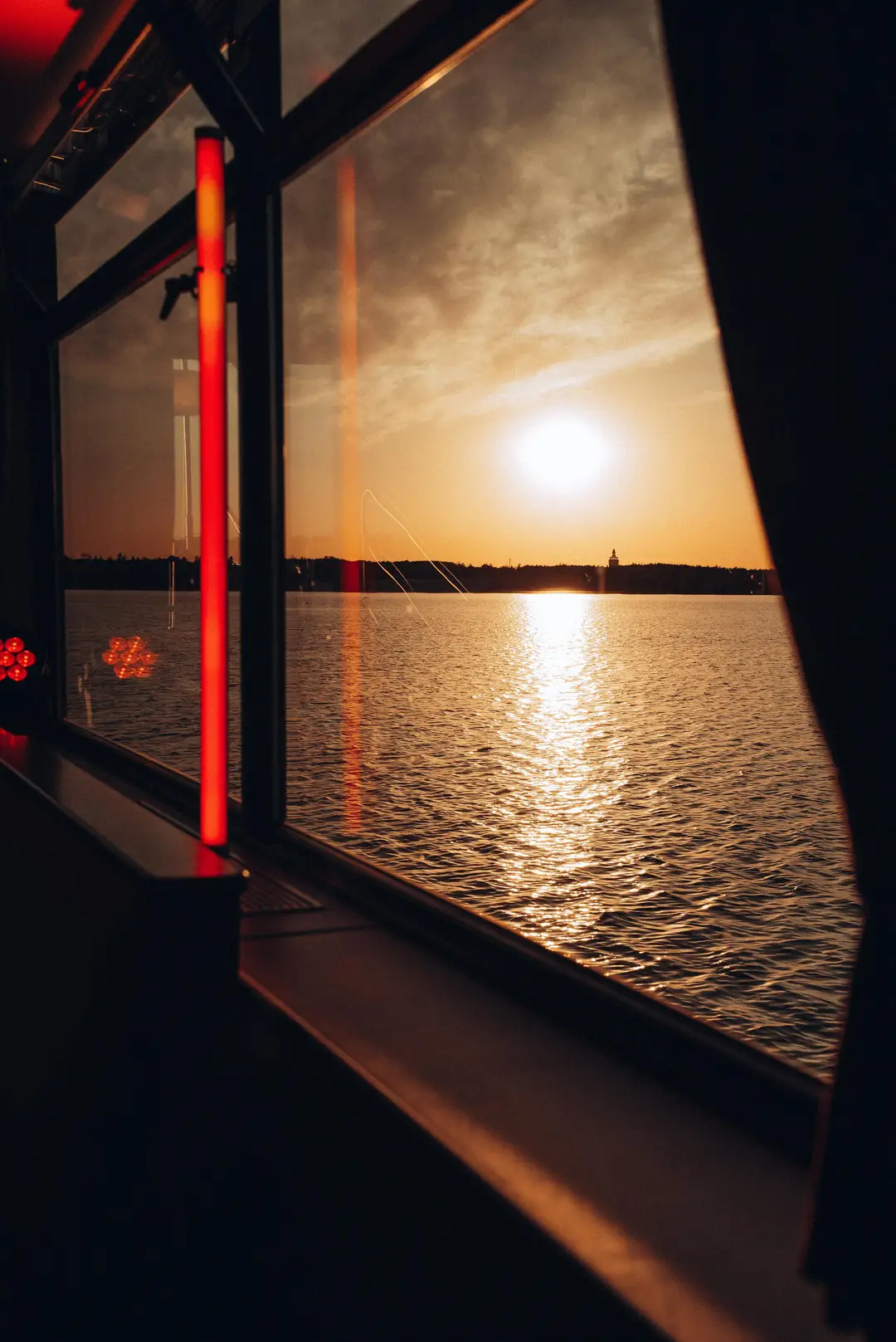 Sunset over the lake through the boat window